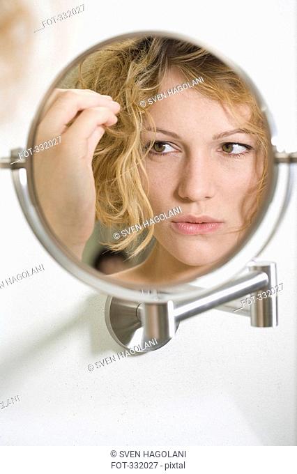 Woman looking anxious in the mirror
