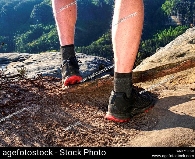Young man strong legs off trail running at amazing summer sunset in sport and healthy lifestyle