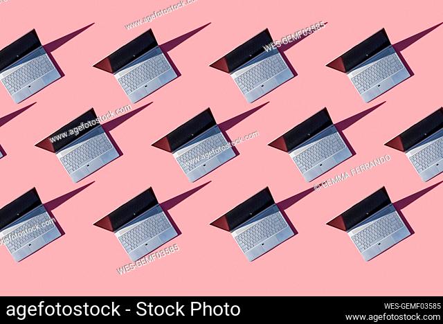 Laptops on pink background