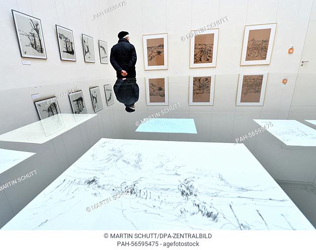 A visitor examines drawings by artist Klaus Bose at the exhibition venue 'Kunsthalle Harry Graf Kessler' in Weimar, Germany, 11 March 2015