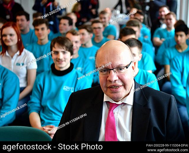 28 February 2020, Brandenburg, Potsdam: Peter Altmaier (CDU), Federal Minister of Economics and Energy, sits in front of the company's trainees during his visit...