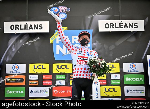 British Matthew Holmes of Lotto Soudal celebrates on the podium in the red polka-dot jersey for best climber after the second stage of 80th edition of the...