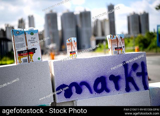 11 June 2021, Lower Saxony, Edewecht: Dairy farmers demonstrate in front of the DKM Deutsches Milchkontor building for reasonable milk prices