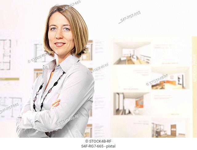 Businesswoman with arms folded in architecture office