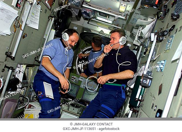 Left to right, cosmonaut Yury V. Usachev, astronaut James S. Voss and cosmonaut Yuri P. Gidzenko visit on the International Space Station soon after hatches...