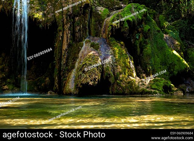 The tufa waterfall near Arbois. Crystal clear waterfall, powerful waterfall