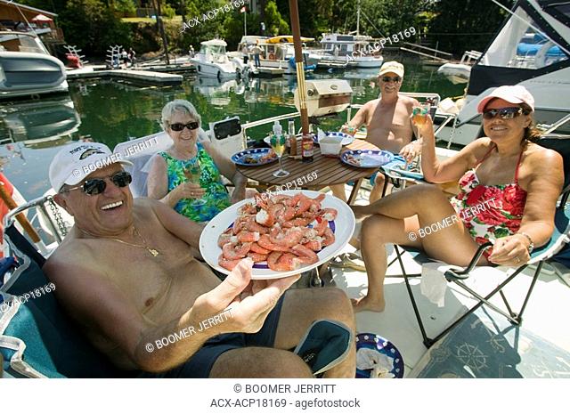 Fresh cooked prawns and a beautiful warm summer afternoon on the back of a boat, Brentwood Bay, Vancouver Island, British Columbia, Canada