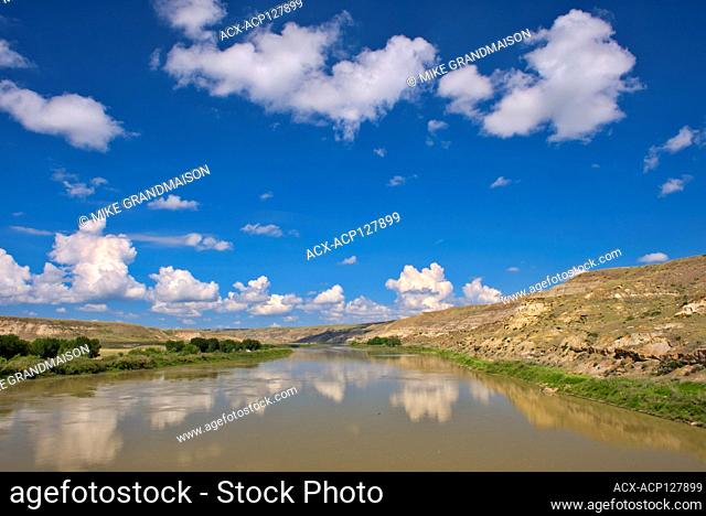 Badlands and clouds reflected in the South Saskatchewan River off Hwy 41 Near Empress Alberta Canada