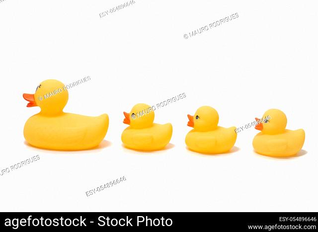 Cute yellow plastic ducks isolated on a white background
