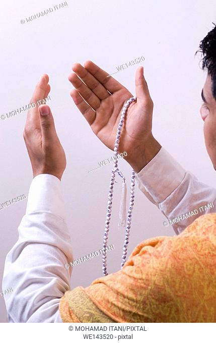 Man raising hands in prayer