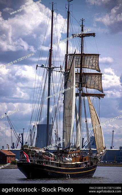 05 August 2021, Mecklenburg-Western Pomerania, Rostock: The schooner ""Gulden Leeuw"" from the Netherlands sails through the sea canal towards the city harbour