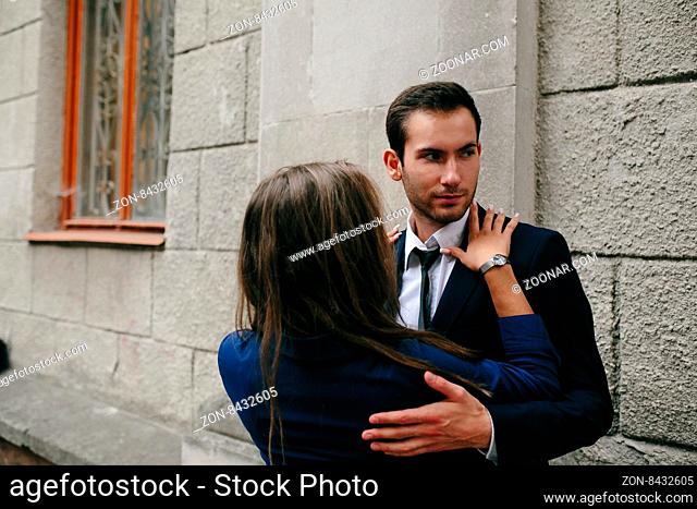girl in the arms of her boyfriend on the street