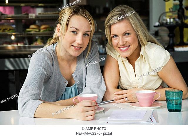 Two women having a business meeting and a cup of coffee in a café Sweden