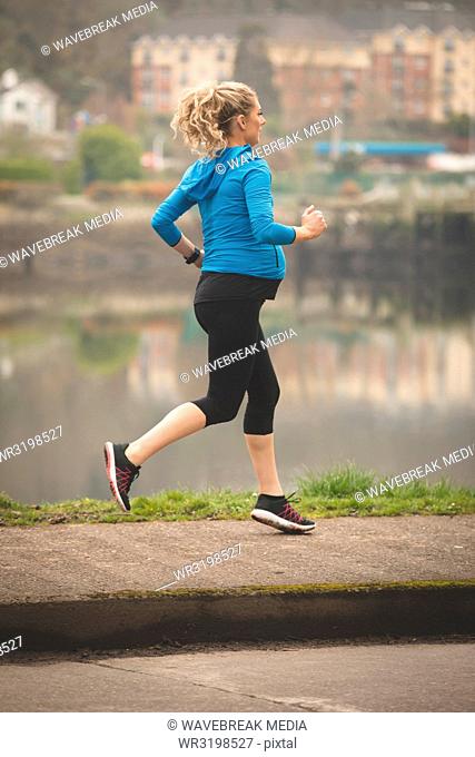 Pregnant woman jogging in the park