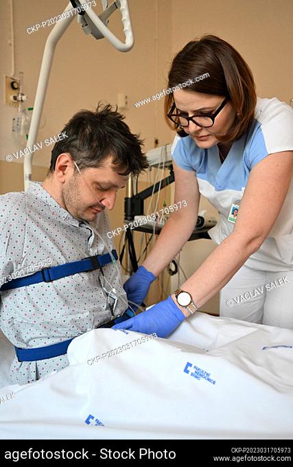 Head nurse Dana Dvorackova, right, helps a patient during an examination in the sleep laboratory of the University Hospital in Brno, March 17, 2023
