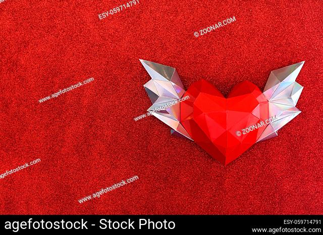Polygonal heart with wings on a soft fleecy red background. Congratulations on Valentine's Day. mock up and copy space