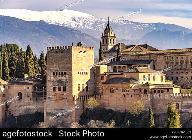 View from Mirador de San Nicolas to the palace and fortress complex Alhambra and the snow-covered Sierra Nevada mountains in Granada, Andalusia, Spain