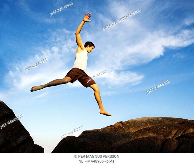 A Scandinavian man jumping on cliffs