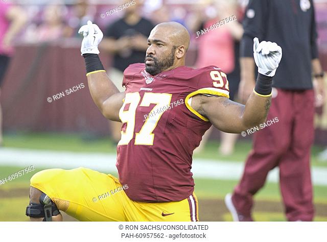 Washington Redskins defensive end Jason Hatcher (97) participates in calisthenics as he warms-up prior to the game against the Detroit Lions at FedEx Field in...