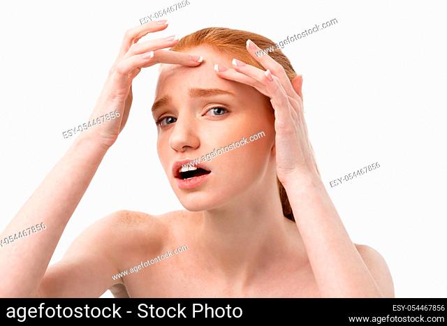 Young caucsian woman squeezes acne on the face of beauty