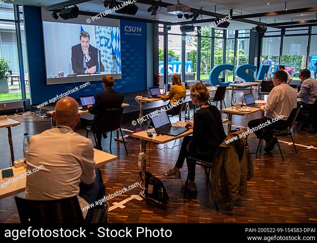 22 May 2020, Bavaria, Munich: Journalists watch the live stream of the CSU party congress. For the first time in the history of the party