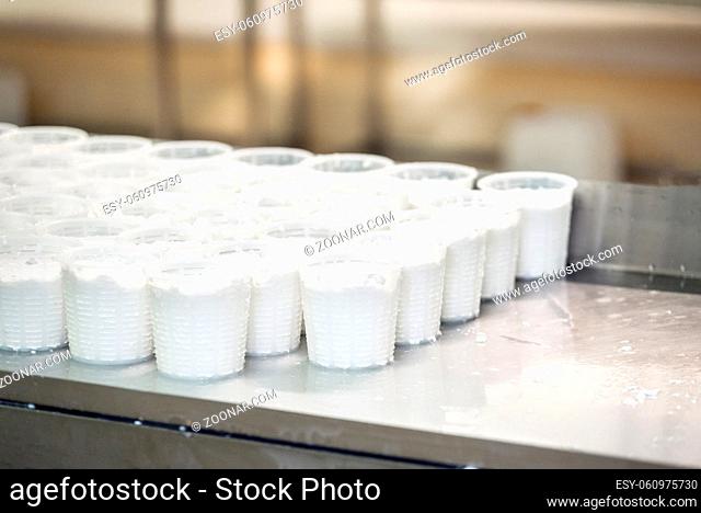 Close up view on many freshly made cottage cheese in plastic package