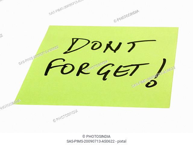 Don't Forget text written on an adhesive note