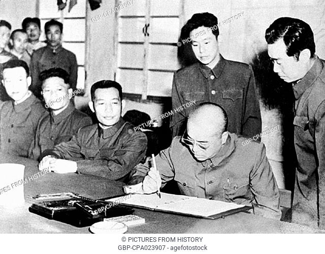 China / Korea: Peng Dehuai (1898-1974), Commander in Chief Chinese People's Volunteer Army in Korea, signs the 1953 armistace agreement ending the Korean War in...