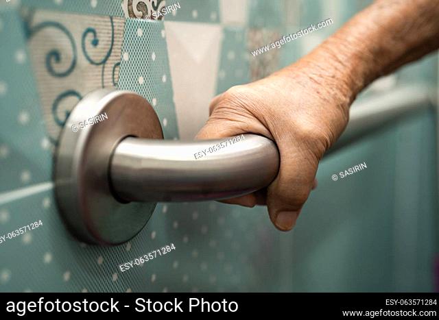 Asian senior or elderly old lady woman patient use toilet bathroom handle security in nursing hospital, healthy strong medical concept
