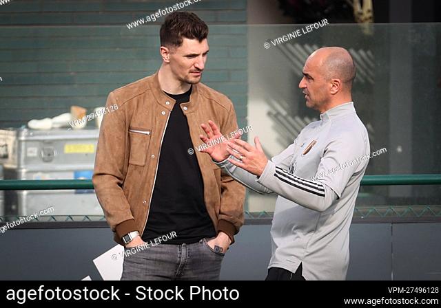 Belgium's Thomas Meunier talks to Belgium's head coach Roberto Martinez during a training session of the Belgian National Team, the Red Devils