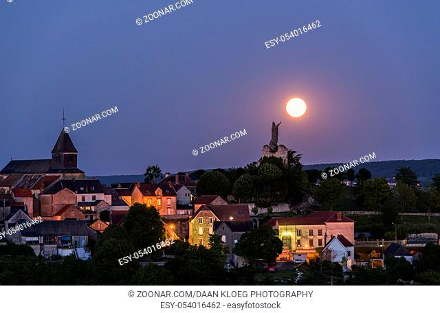 The statue of Pope Urbanus 2 in the Champagne village of Chatillon-sur-Marne in the Champagne district in France rising of the moon