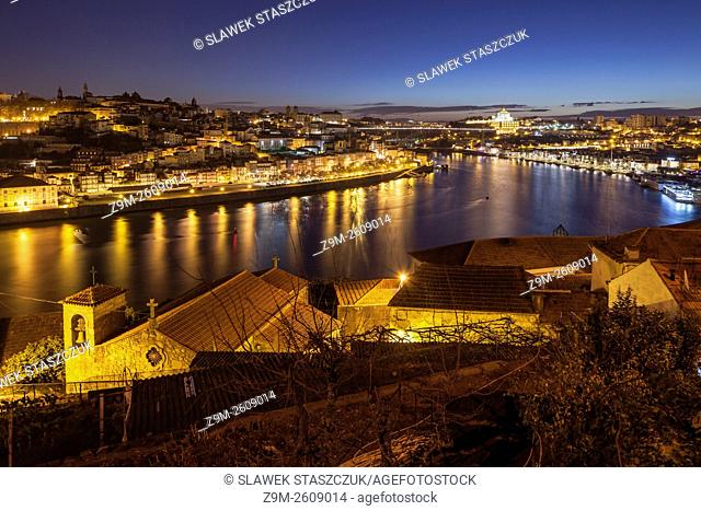 Dawn in Porto, Portugal. Looking along river Douro towards Luiz I Bridge