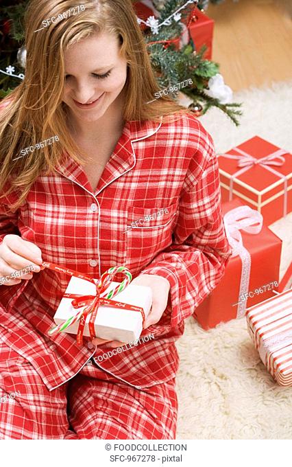 Woman opening Christmas parcel
