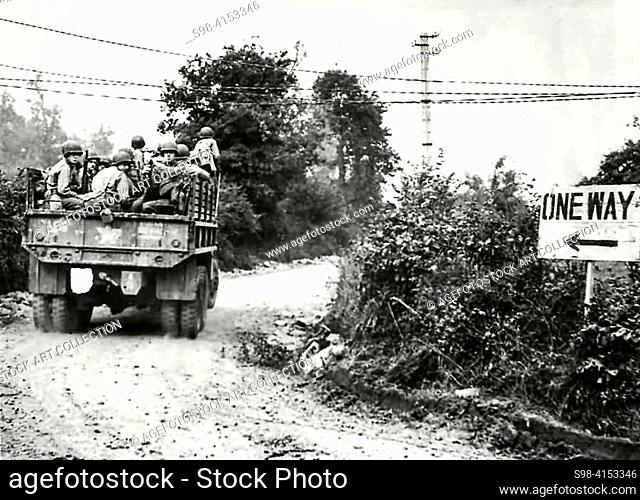 World War II - FRANCE. Invasion of Normandy 1944, GMC truck loaded with US troops of the 4th Infantry Division move up to the front on July 23rd for Operation...