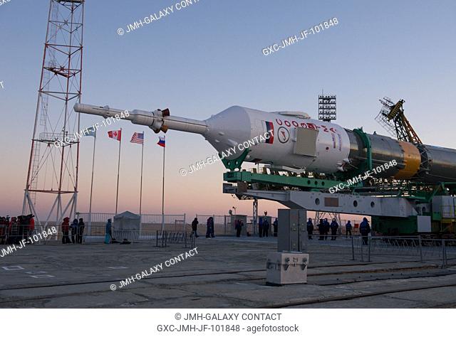 The Soyuz rocket is erected into position after being rolled out to the launch pad by train on Dec. 17, 2012, at the Baikonur Cosmodrome in Kazakhstan