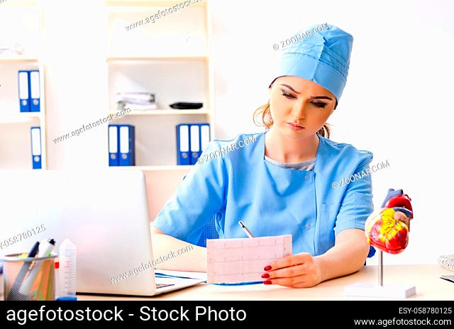 Young female doctor cardiologist sitting at the hospital