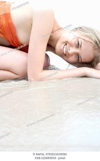 cheerful woman lying on the beach