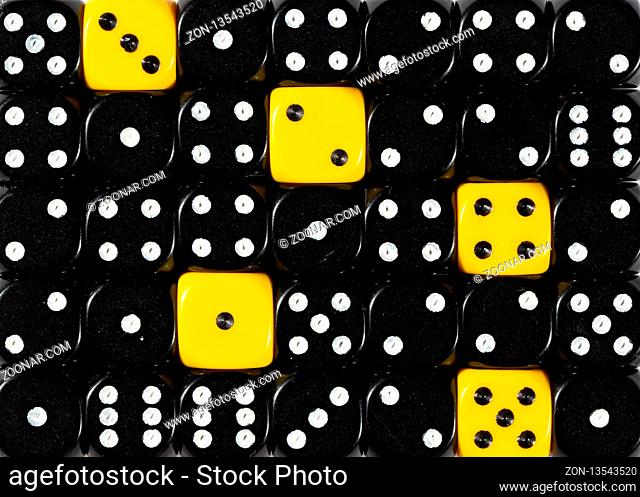 Pattern background of random ordered black dices with five yellow cubes