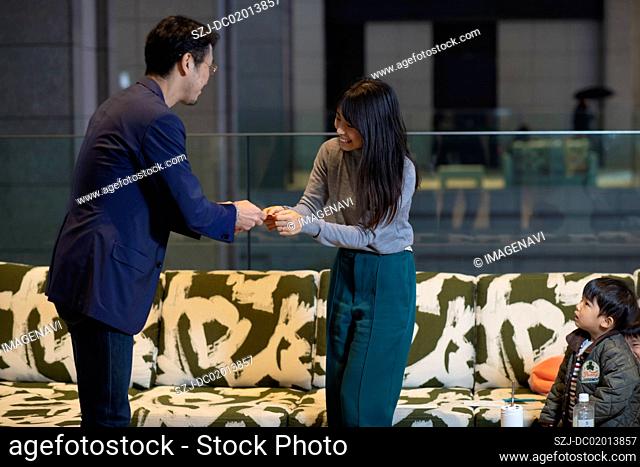 Businessman and woman having meeting with child