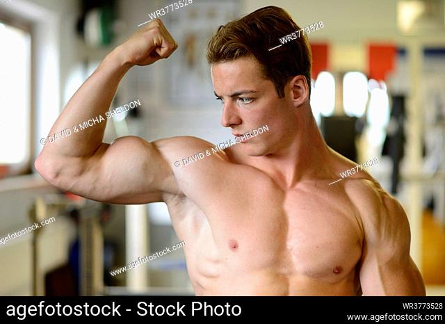 Young man posing in fitness center