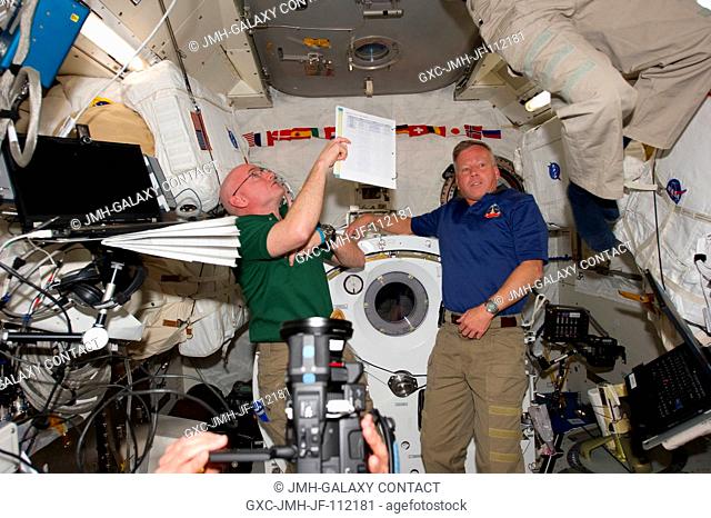 NASA astronauts Scott Kelly (left), Expedition 26 commander; and Steve Lindsey, STS-133 commander, are pictured in the Kibo laboratory of the International...