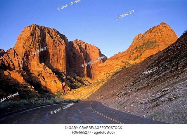 Sunset light on red rock sandstone cliffs above the Kolob Canyons Road, Kolob Canyons, Zion National Park, Utah, USA