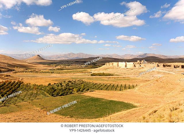 The ruin of Takht-i Soleiman set among fields of crops in Iran