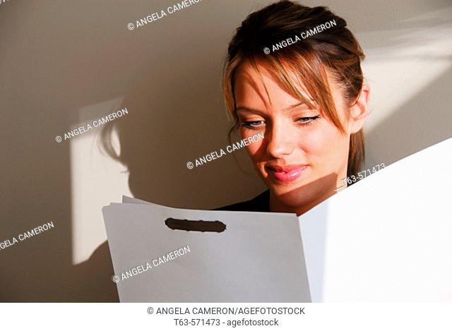 20 yr old young woman looking at file folder