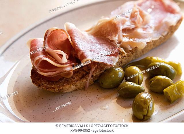 Ham Toast with olives. Spain