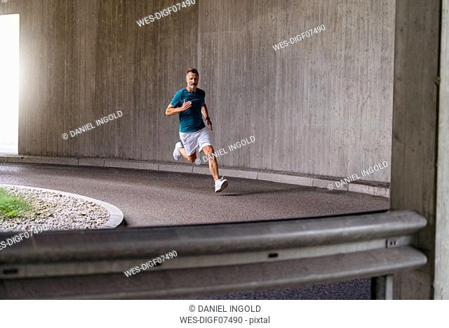 Sporty man sprinting on a street
