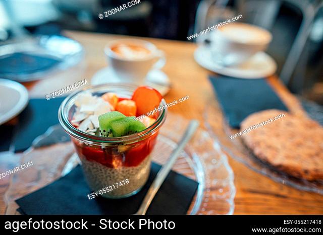 Cocktail of fresh fruits and milk in a glass on the table