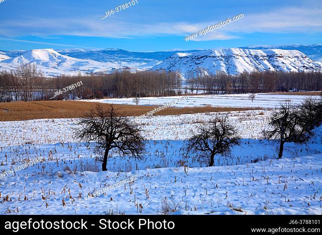 Snowy landscape in the course of the Turia river, in Villaspesa with the Sierra Javalambre at background. Teruel