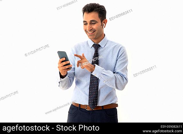 A CORPORATE MAN HAPPILY USING MOBILE PHONE