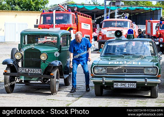 24 July 2020, Saxony-Anhalt, Beuster: An Opel 1.2 litre (l) police car from 1934 will be on display at the Blue Light Days in the Blue Light Museum Beuster on...